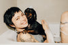 Photo Image of A Woman with her Dog Together In Taking a Bath.